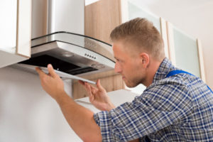 electrician installing a range hood